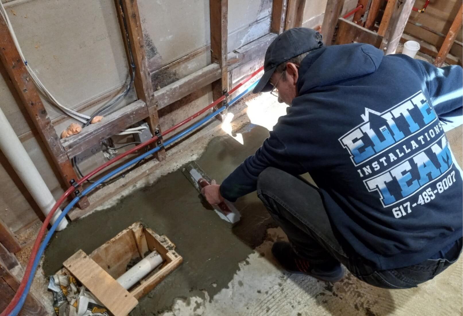 a man using a cement block to put concrete on the floor