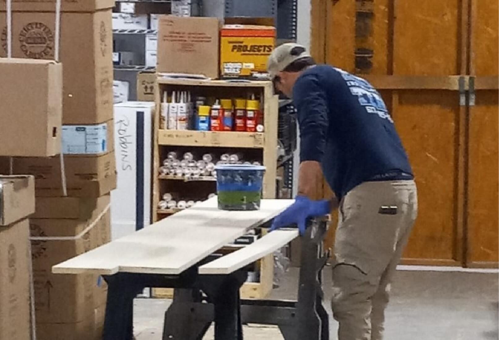 a man in gloves working on a table