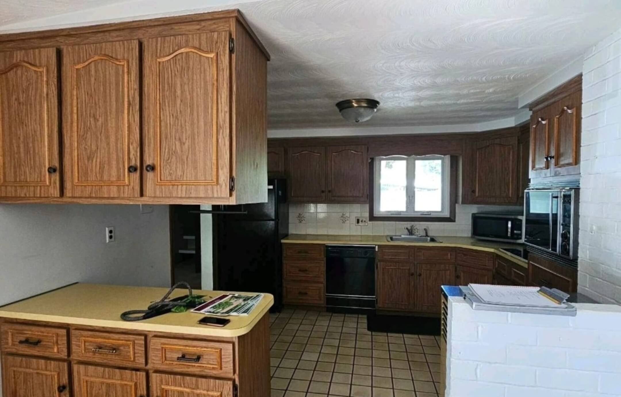 Worn cabinets and cluttered space before kitchen remodeling Framingham